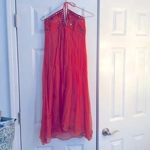 Mid length halter dress. Embroidered details. Tiny bells on the ties